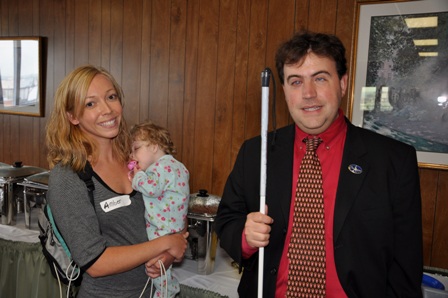 Mark Riccobono visiting with a parent from the conference and her blind daughter.